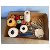 Spools of thread, embroidery hoop, knitting