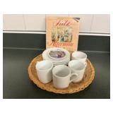 Tea set, white cups, saucers, book, wicker plates