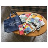 Shopping bag, road atlas books, travel maps