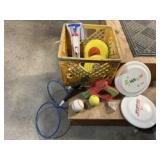 Crate of frisbees, balls, pump, badminton raquets