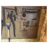 Contents of pegboard, metal files, pipe wrench,