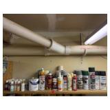 Shelf of consumables, spray paint, craft paint