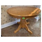 Round oak pedestal dining table