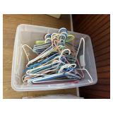 Tote of plastic clothes hangers