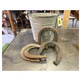 Galvanized pail of horse shoes