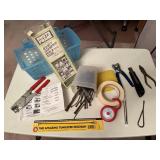 Basket of square nails, adhesives, light, hand