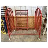 Red metal baby crib