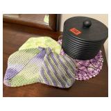 Canister, handmade potholders, doilie