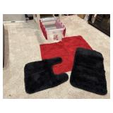 Black bath rugs, red floor rugs, storage tote