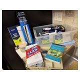 Tote of office supplies, envelopes, pens, paper