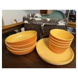 Plastic plates, bowls, lined storage basket