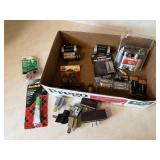 Box of batteries, adhesives, outlet adapters