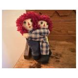 Hugging Raggedy Ann & Andy dolls