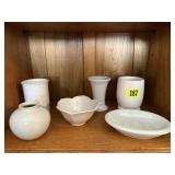 Shelf of white dishes, soap dish, vases