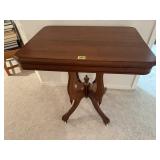 Antique parlor table on casters