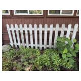 Staked white picket fence
