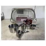 Sink colander, stainless measuring cups, spoons