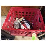 Plastic crate, power cords, USB cable, surge