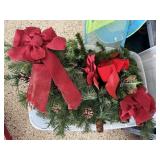 Storage tote of holiday greenery, swags