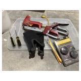 Bucket of tools, staplers, flag holder