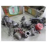 tins of carburetors and parts