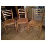 three wood chairs