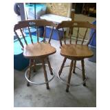 two swiveling wood bar stools
