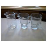 three glass pitchers
