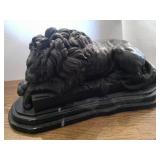 bronze sleeping lion on marble stand