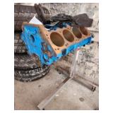 motor block and parts on stand