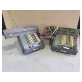 two Monroe adding machines