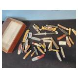 Small pocket knives in wood box