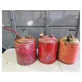 three metal gas cans