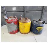 three metal gas cans