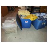 three totes with bedding