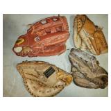 4 old baseball mitts