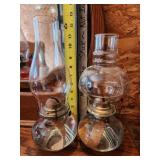 two clear oil lamps