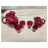 ruby red pitcher and glasses, one has chip