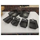 Six decorative black plastic storage trays