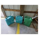 Three plastic water storage jugs