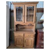 Oak two-piece curio cabinet with leaded glass