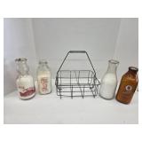 Vintage glass milk bottles and galvanized carrier