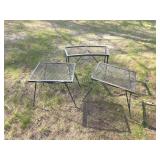 Three black metal mesh outdoor patio tables