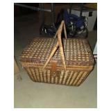 Vintage wicker picnic basket with dishes
