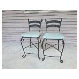 Two black wrought iron bar high top bar stools