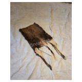 Partial animal hide with hooves