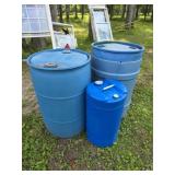 Three plastic storage barrels