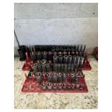 Four plastic storage trays with large assortment
