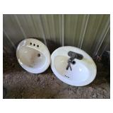 Two porcelain oval drop in bathroom sinks
