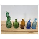 Five vintage small glass bottles and salt pepper